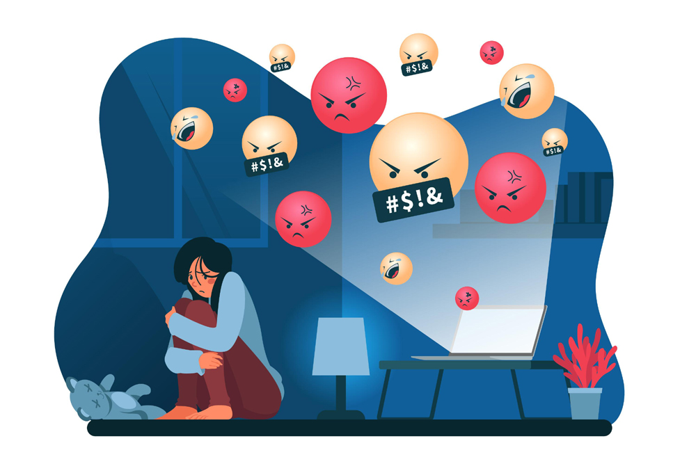 Ilustração de uma jovem abraçada às pernas, sentada em um canto de um quarto escuro, iluminado apenas pelo feixe de luz de um notebook sobre uma mesa. Emojis de riso, raiva e xingamento emergem da luz emitida pela tela. A expressão da garota diante do notebook é de medo e apreensão. A ilustração faz alusão à temática dos discursos de ódio na internet. Ilustração de uma jovem abraçada às pernas, sentada em um canto de um quarto escuro, iluminado apenas pelo feixe de luz de um notebook sobre uma mesa. Emojis de riso, raiva e xingamento emergem da luz emitida pela tela. A expressão da garota diante do notebook é de medo e apreensão. A ilustração faz alusão à temática dos discursos de ódio na internet.